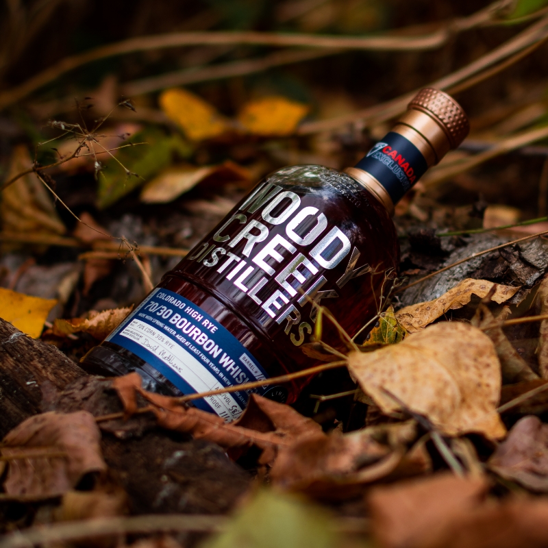 woody creel bottle in pile of leaves