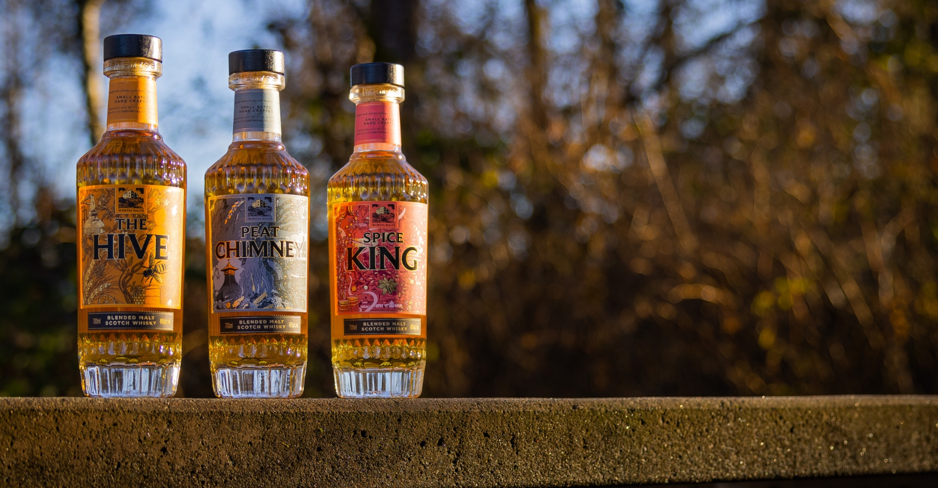 wemyss blended malts on a stone ledge with brown foliage in the background