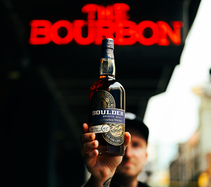 DSC-6987 (1) Man holding a bottle of bourbon