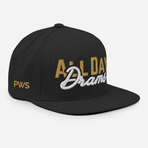 Black snapback hat with a flat brim, featuring raised "ALL DAY" embroidery in gold block letters and "Drams" in white script letters on the front.